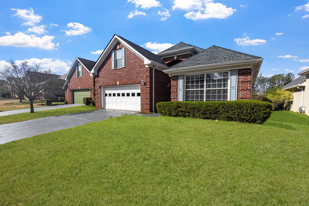 Red brick house with a wide, freshly mowed front lawn